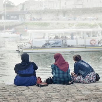 LA ROCHELLE, FRANCE - AUGUST 12, 2015: Muslim woman wearing hijab looking on the ocean Atlantic and yachts at La Rochelle, France.
